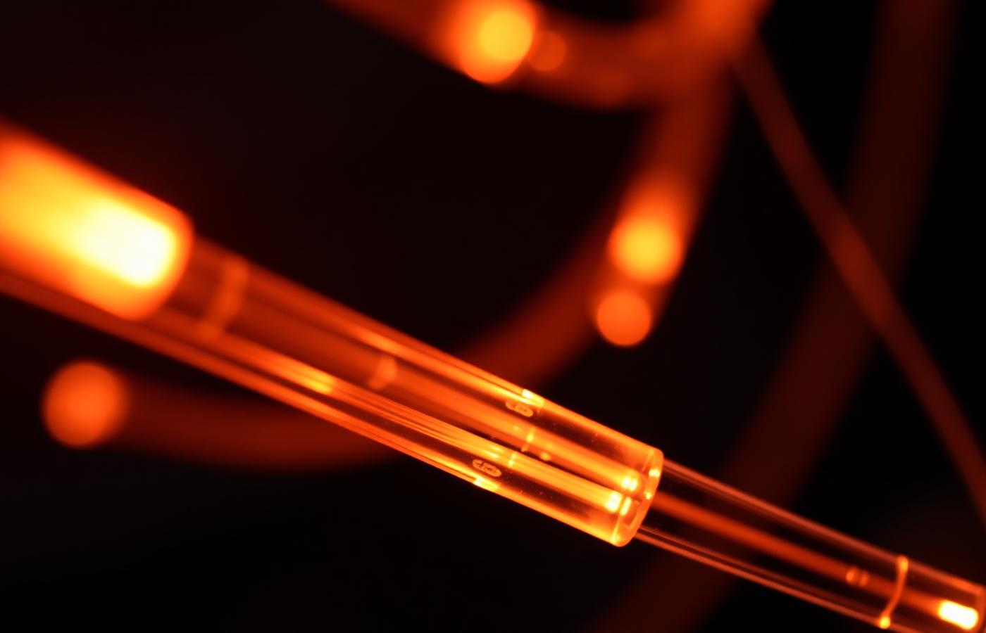 Illuminated fibre-optic cables representing digital communications